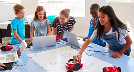 Childerns doing group study with laptop and toys