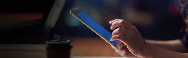 The hand of a person operating a tablet