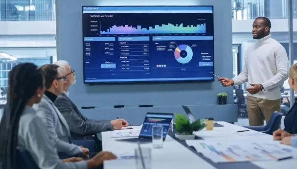 A man presenting graphical data in a meeting.