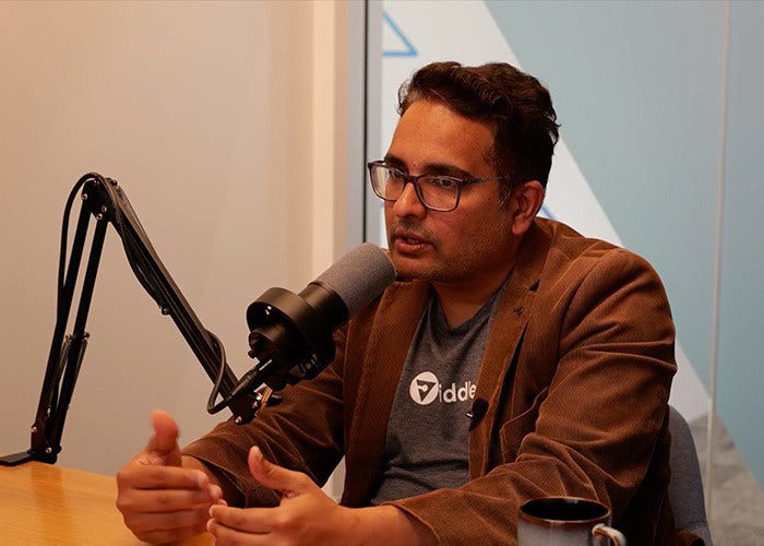 A person is speaking to a mic sitting on a table