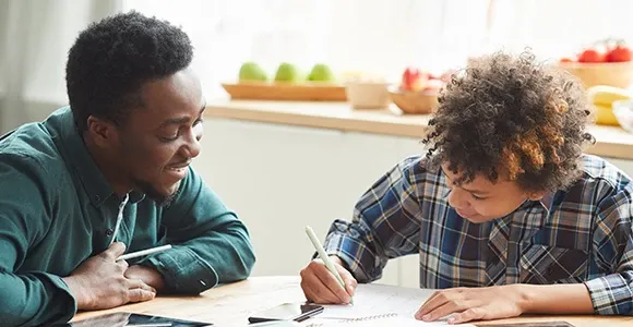 Two school boy working on assignments.