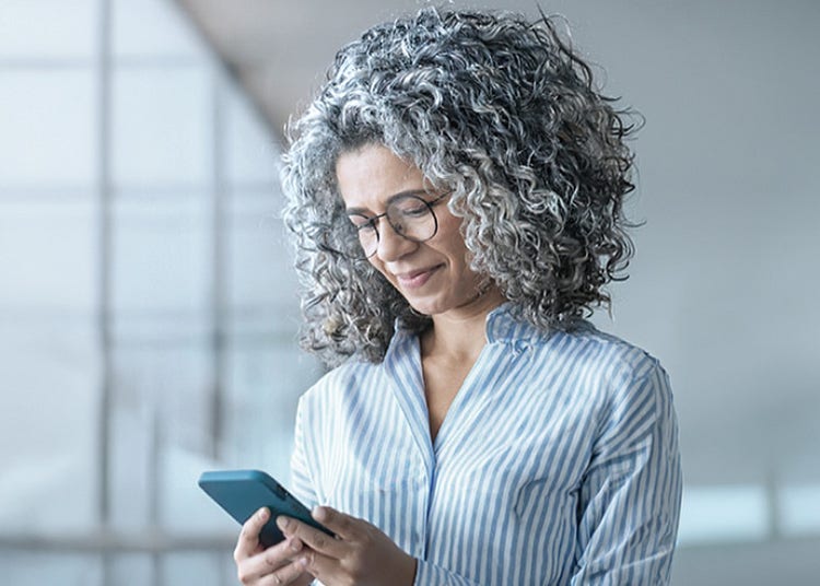 A woman looking down into her phone