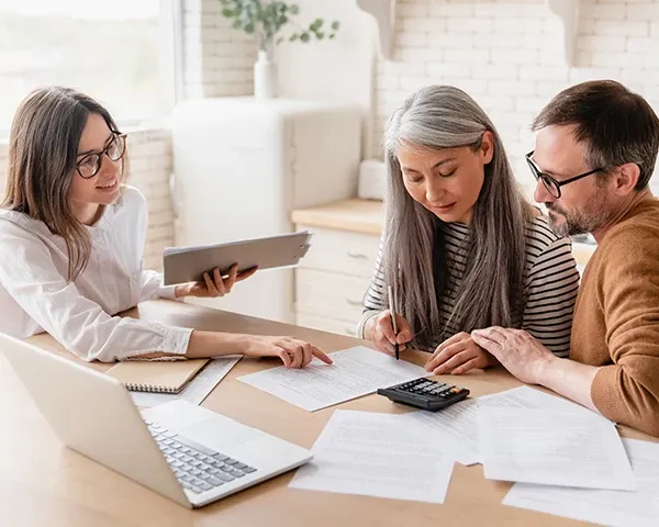 People discussing paperwork with a tablet at home