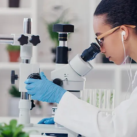 Lab technician using a microscope