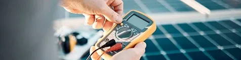 Hands holding a multimeter