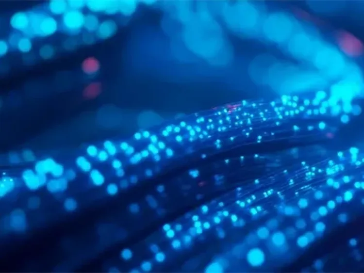 Glowing blue fiber‑optic strands creating a flowing light pattern