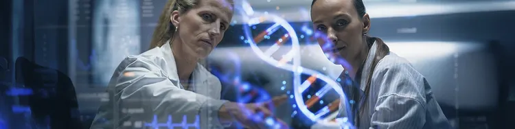 Two scientists in lab coats examine a DNA structure model in a laboratory setting.