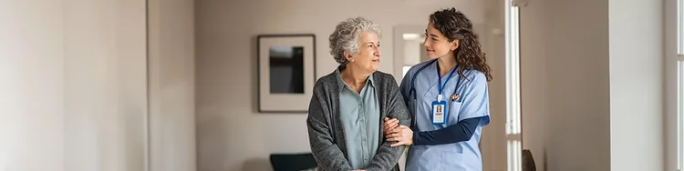 A caregiver holding an old person