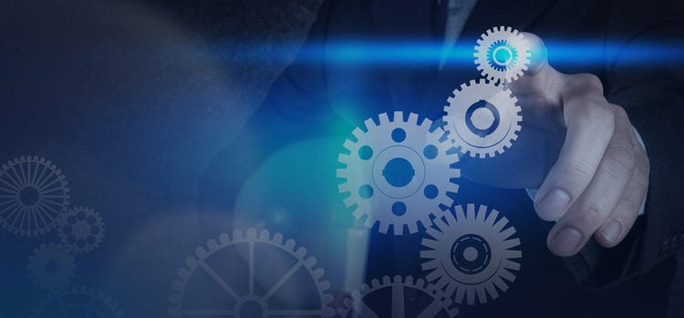 A hand interacting with interconnected circular metal gears