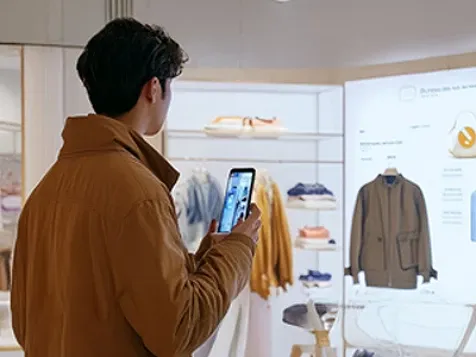A man on a video call on his phone while shopping.