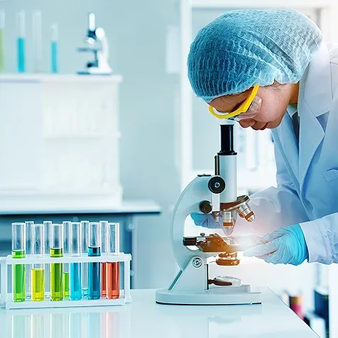 woman looking trough microscope