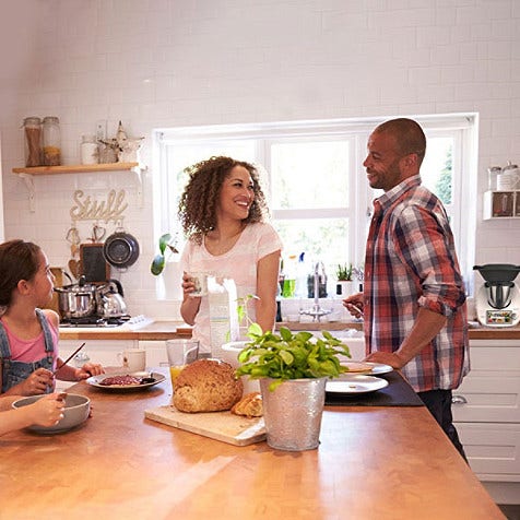 A family hanging around the kitchen table