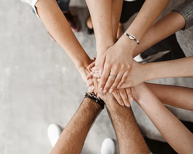 An overhead view of a team hand-stack or huddle